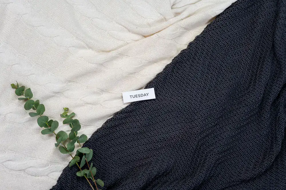 Large knitted textured blanket over a sofa