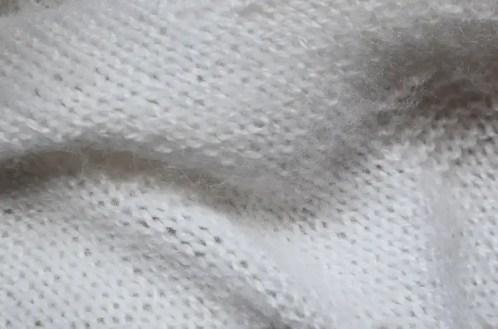 Close up of soft yarn textures and knitted swatches